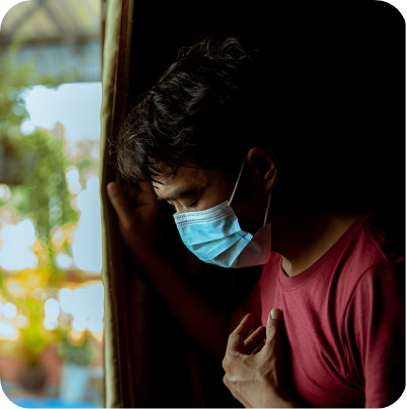 An Asian man wearing a mask has a side effect after suffering from COVID-19