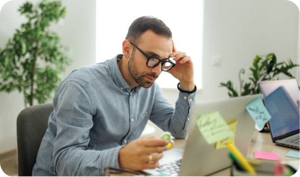 Young well dressed businessman working at office, using fidget spinner for stress relief 