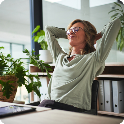 Relaxed business woman sitting at her desk