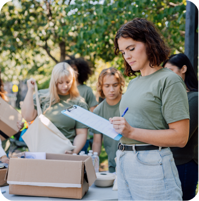 Young team of people unpacking boxes, helping the local community