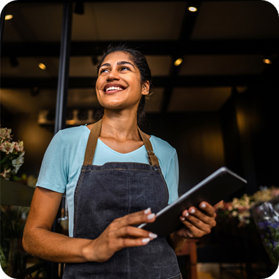 Young saleswoman contemplating at a garden center