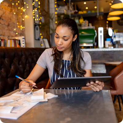 Small business owner doing the bookkeeping at a coffee shop