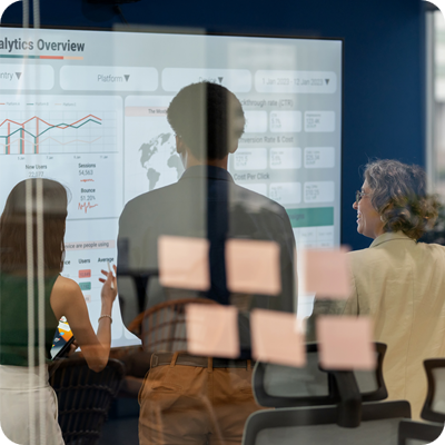 Professionals in a business meeting looking at a presentation