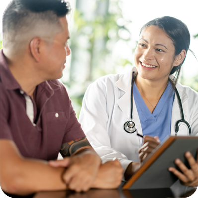 A middle-aged male patient, of Asian decent, sits across from his female doctor as they review some recent test results together