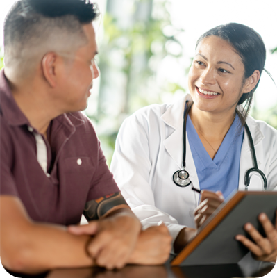 A middle-aged male patient, of Asian decent, sits across from his female doctor as they review some recent test results together