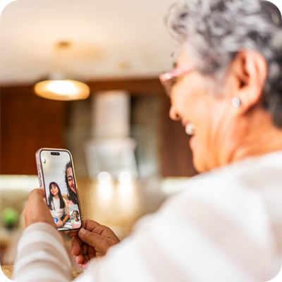 Senior woman talking to family on video call at home