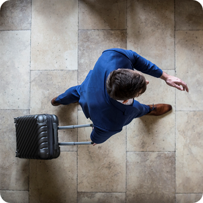 High angle view of an unrecognizable Caucasian businessman with a suitcase traveling