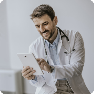Male doctor using tablet computer in hospital room 
