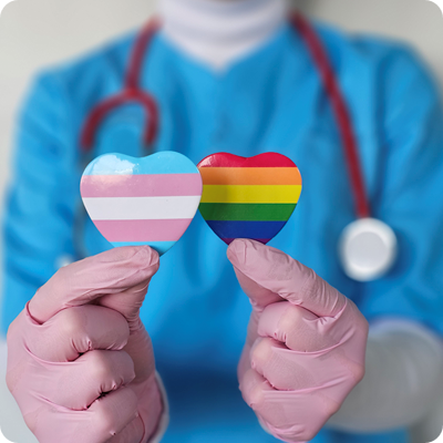 Healthcare worker holding transgender and rainbow pride symbols while advocating for inclusivity in medicine concept