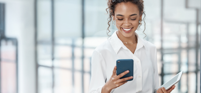 Woman smiling and using phone