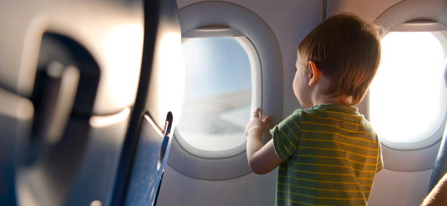 Child looking out the plane window