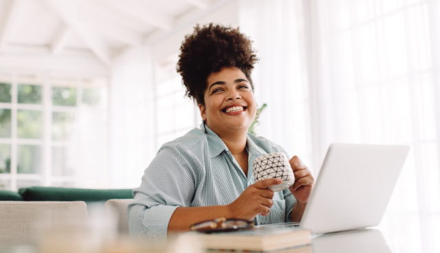 Lady smiling while using a laptop