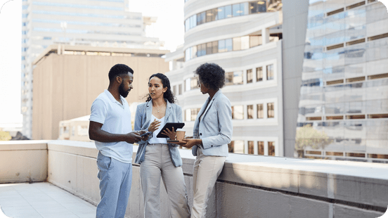 Global Underwriting: Coworkers discussing at the office rooftop.