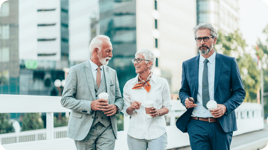 Pension: Senior coworkers walking outside and discussing.