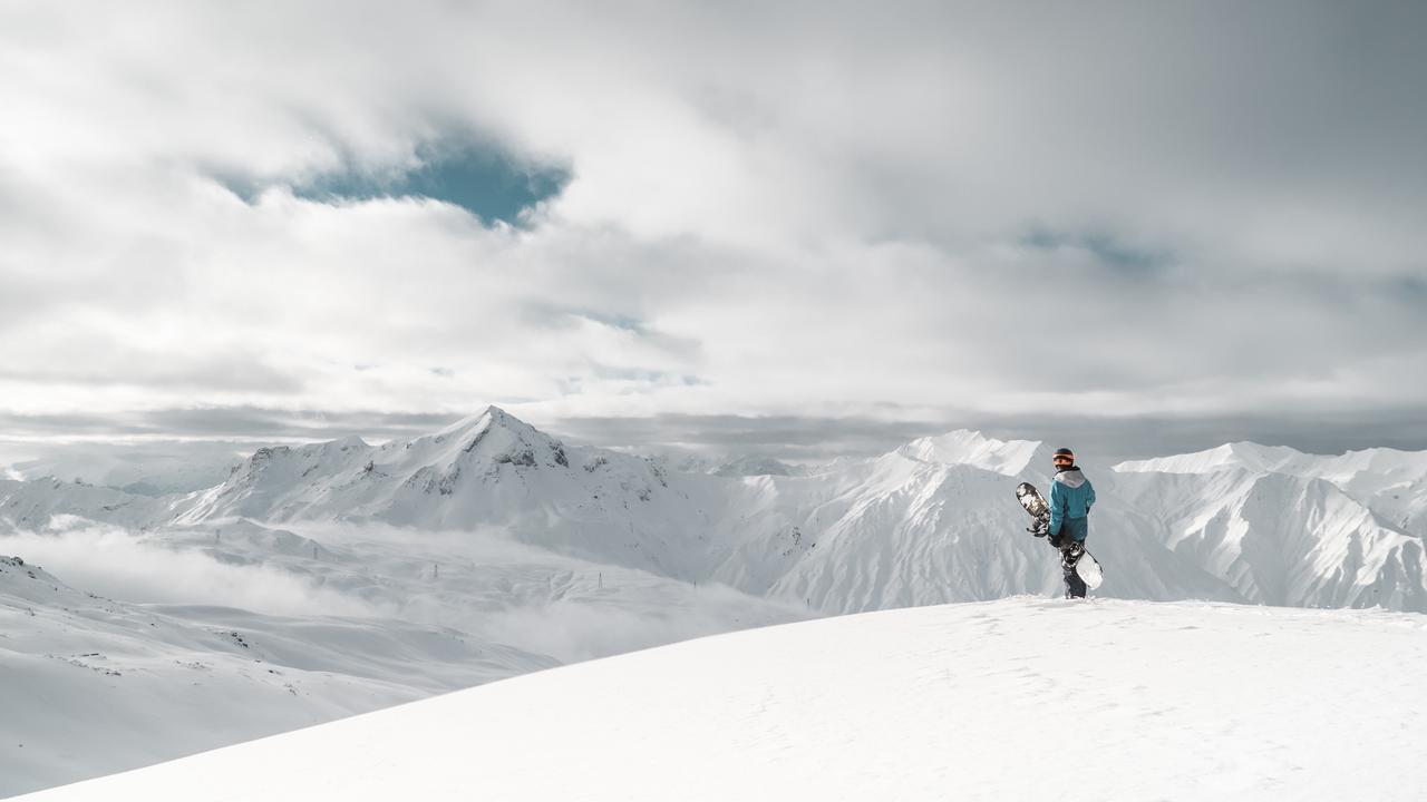 Athlete skier jumps over mountain