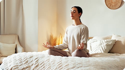 Woman smiling, sitting in a café reading an article  