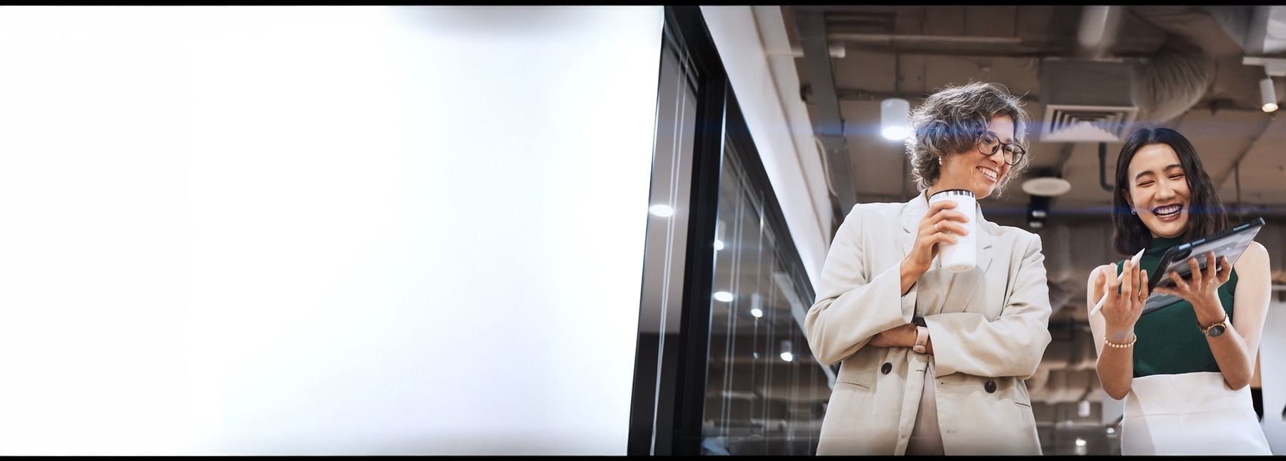 Business colleagues checking ipad during a coffee break.